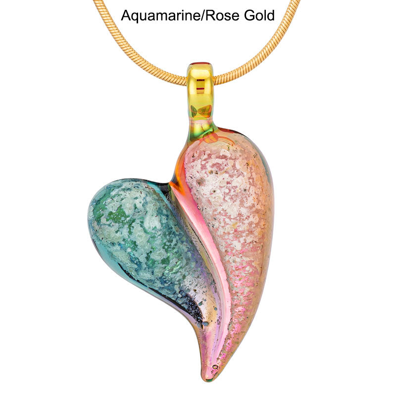 An aquamarine and rose-gold glass heart memorial pendant hangs from a yellow-gold snake chain.