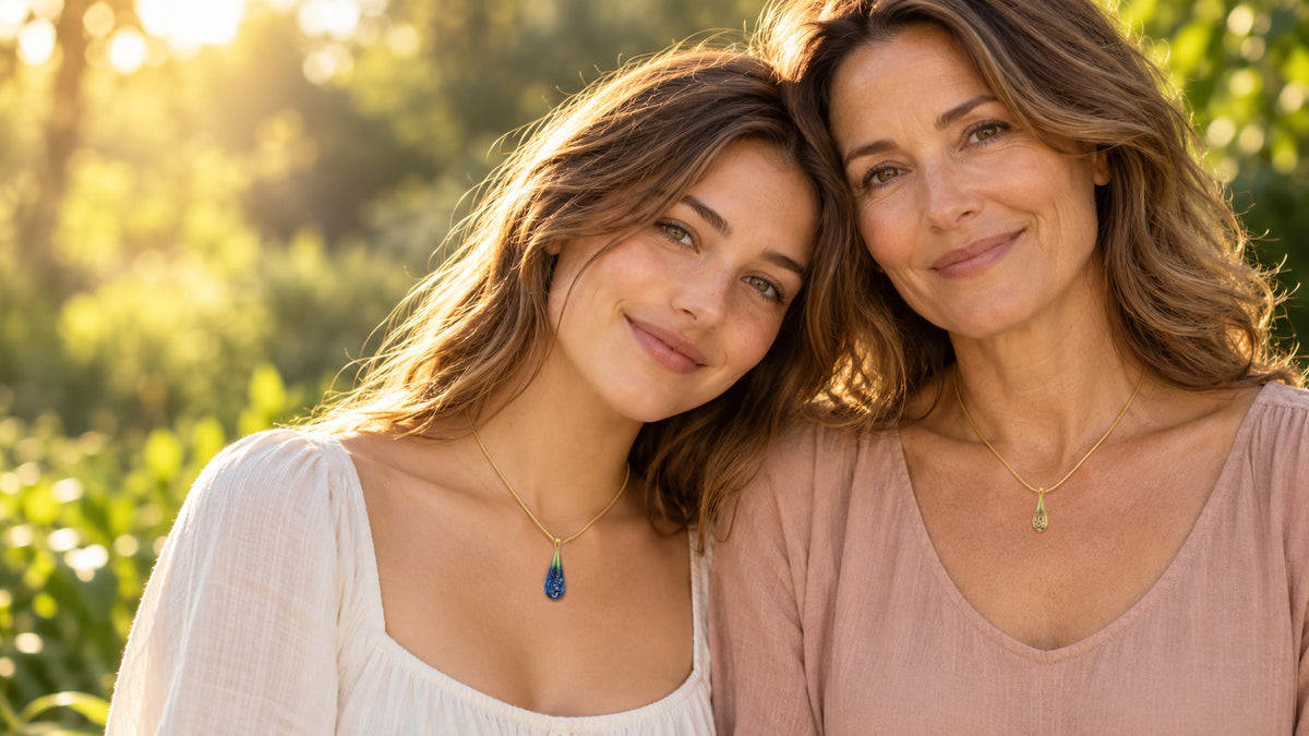 A mother wearing a Champagne glass teardrop cremation pendant and her daughter wearing a Black Opal teardrop pendant