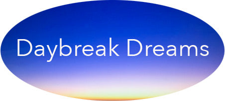 The Daybreak Dreams logo is an oval showing an orange fading to blue sunrise with the words Daybreak Dreams imposed over it.