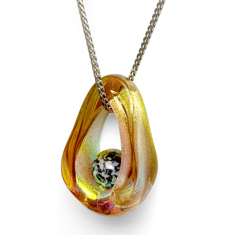 Portal Pendant - A mesmerizing dichroic glass pendant surrounds an ash-infused glass orb symbolizing the eternal presence of a loved one while hanging from a chain necklace.