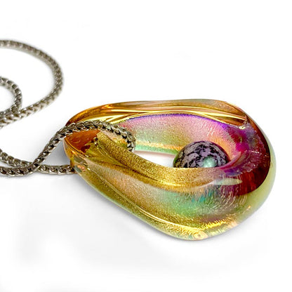 Portal Pendant - A mesmerizing dichroic glass pendant with an infused cremated remains orb symbolizes the eternal presence of a loved one while shown from a sideview.