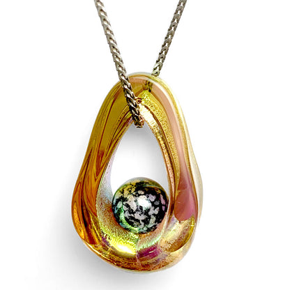 Portal Pendant - A mesmerizing dichroic glass pendant with an infused cremated remains orb symbolizes the eternal presence of a loved one while hanging from a chain necklace.