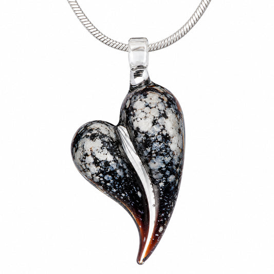 A speckled black Obsidian glass heart cremation pendant infused with a loved one's ashes