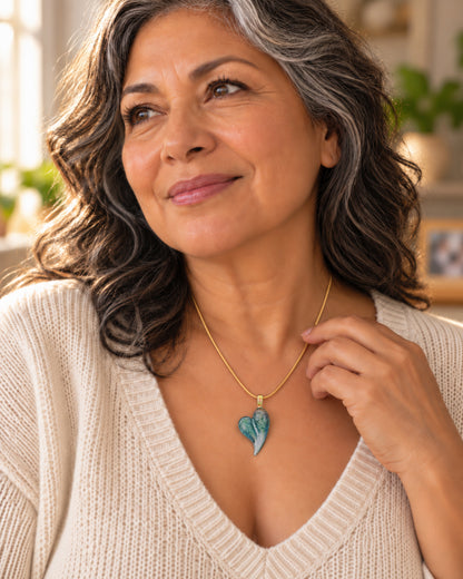 A woman wearing an Aquamarine glass heart cremation pendant made with a loved one's ashes