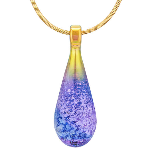 A blue and purple glass teardrop pendant necklace infused with cremation ashes, showcased on a sturdy gold snake chain against a clean white background.
